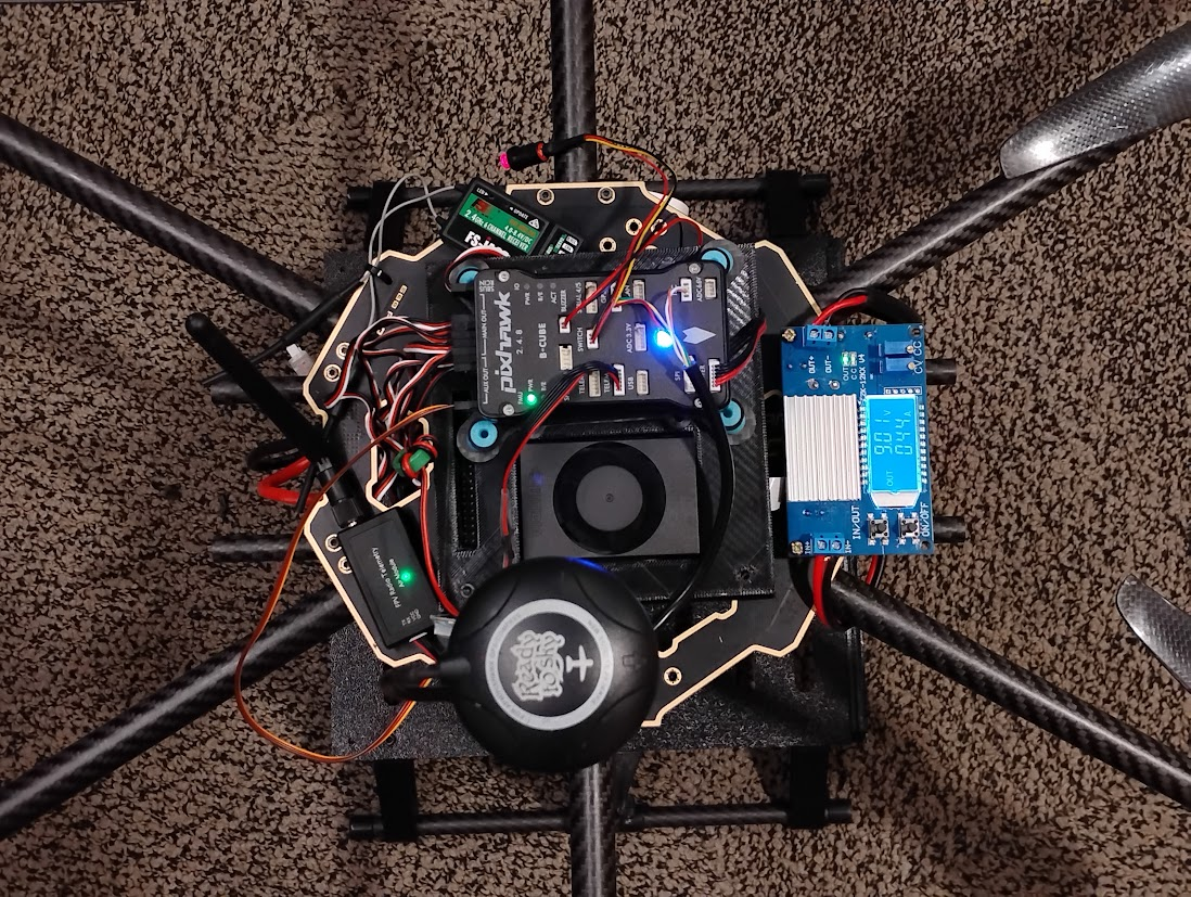 Carbon fiber hexacopter from above with Pixhawk, GPS, and wiring on the frame