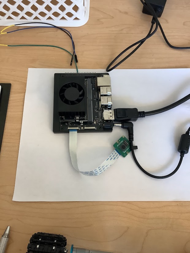 NVIDIA Jetson Orin Nano on a bench with a CSI camera on a ribbon cable