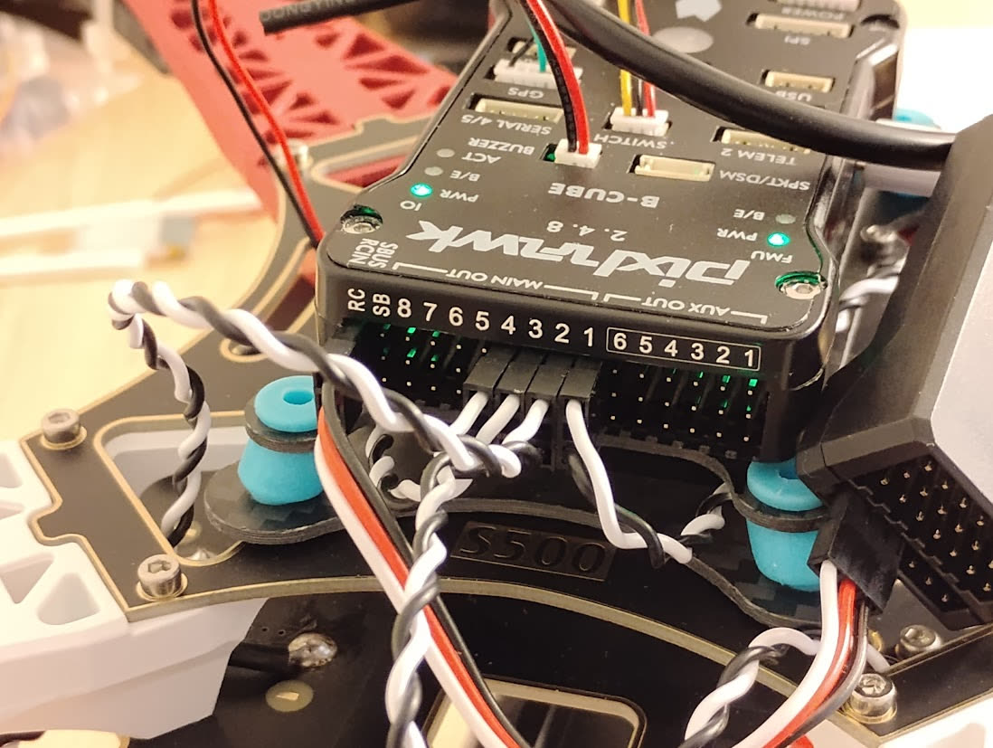Close-up of a Pixhawk 2.4.8 B-Cube with servo wires in the main out ports
