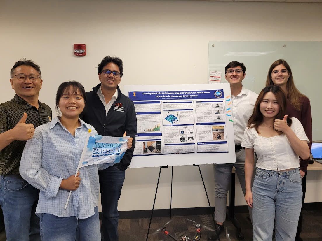 Team QuadBots standing with their research poster
